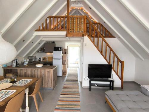 a living room with a staircase and a kitchen at Seaside Glow in Schinias