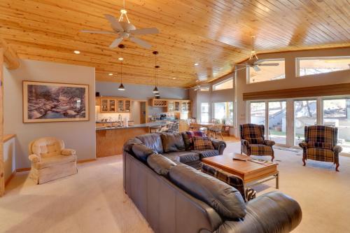a living room with a couch and a table at Patio and Forest View Peaceful Show Low Home in Show Low
