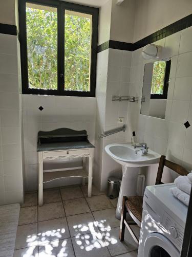 a white bathroom with a sink and a mirror at RiverRun in Saint-Geniez-dʼOlt
