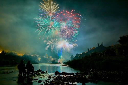 people standing on the beach watching a fireworks display at RiverRun in Saint-Geniez-dʼOlt