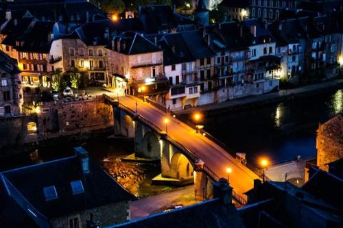 a bridge over a river in a city at night at RiverRun in Saint-Geniez-dʼOlt