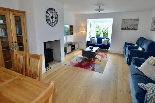 a living room with a couch and a fireplace at 3 double bed house with parking in Sheringham in Sheringham
