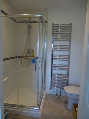 a bathroom with a shower and a toilet at 3 double bed house with parking in Sheringham in Sheringham