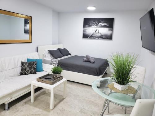 a living room with a couch and a table at Apts with Backyard Near Fort Lauderdale Beach, Nightlife, Cruise Port, Airport in Fort Lauderdale