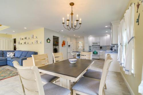 a dining room and living room with a table and chairs at Plymouth Getaway with Private Lake Beach and Kayaks! in Plymouth