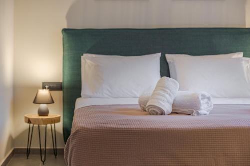 a bed with two rolled towels on top of it at The Mulberry Tree Villa in Sami