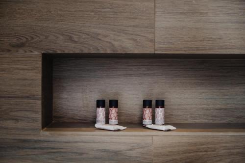 three bottles of essential oils sitting on a shelf at The Mulberry Tree Villa in Sami