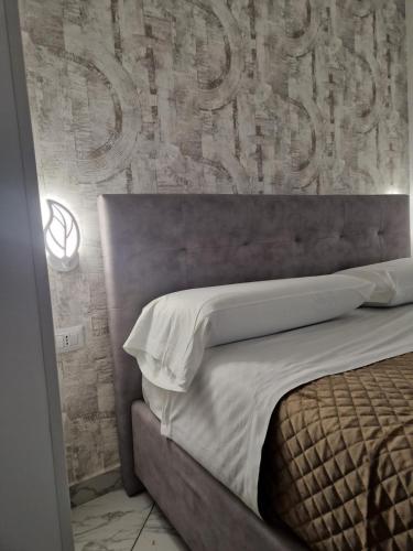 a bedroom with a bed with a large sign on the wall at Eden in Lamezia Terme