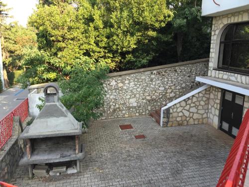 a stone wall next to a stairway to a building at Pansion Ruža in Novi Vinodolski