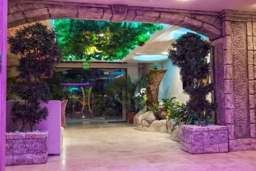 a lobby with an arch with plants in it at Harmony Suites Jungle - Apartment Veron in Sunny Beach