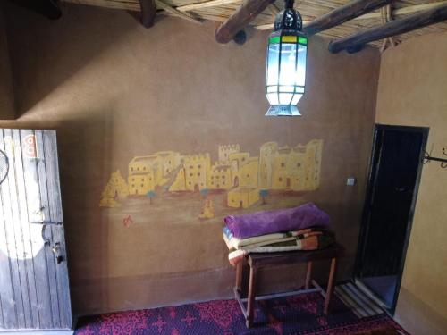 a room with a wall with a painting on the wall at Auberge Dar Lajdoud in Tafraoute Sidi Ali