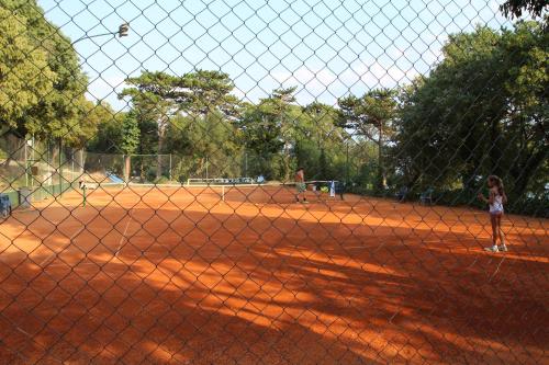 a young girl standing on a tennis court at Pansion Ruža in Novi Vinodolski