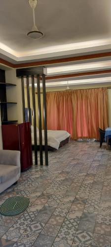 a room with two beds and a tiled floor at Sea view Sun shine in Calangute