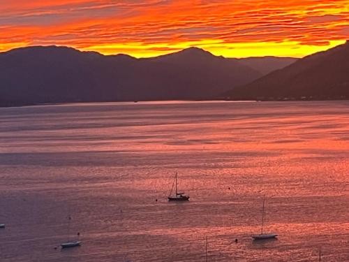a group of boats in the water at sunset at Flat in Gourock - The Wedge in Gourock