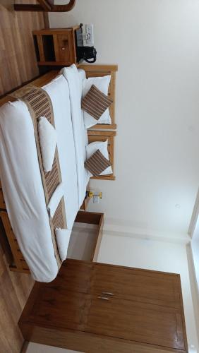 a row of pillows on a bed in a room at Kazdar Villa in Leh