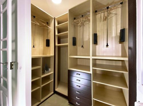 a walk in closet with wooden shelves and cabinets at Entre Algodones in Logroño
