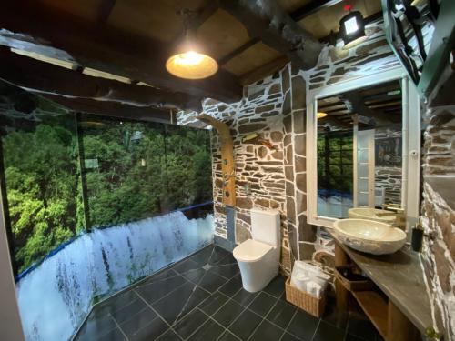 a bathroom with a sink and a mirror at O Forno de Catuxa Cottage & Roman Wall in Lugo