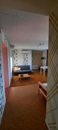 a living room with a couch and a table at Småland Eksjö 2 mooie appartementen in Höreda