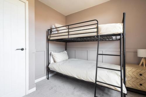 a bedroom with two bunk beds and a window at Host & Stay - High Street in Loftus