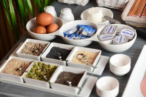 a table topped with containers of food and bowls of ingredients at Little Italy Hostel Ex Chiesa S Donato in Perugia
