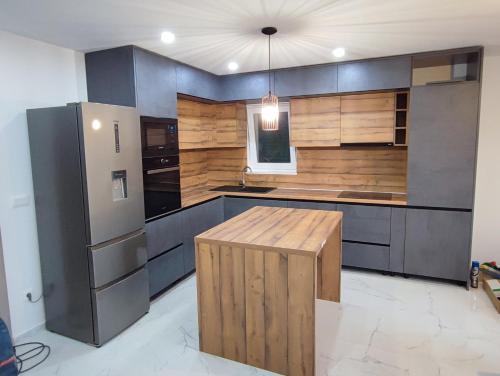 a kitchen with a refrigerator and a table in it at Vila Lavanda Povljana in Povljana