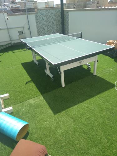 a ping pong table sitting on top of grass at Il Cuore di Trapani in Trapani