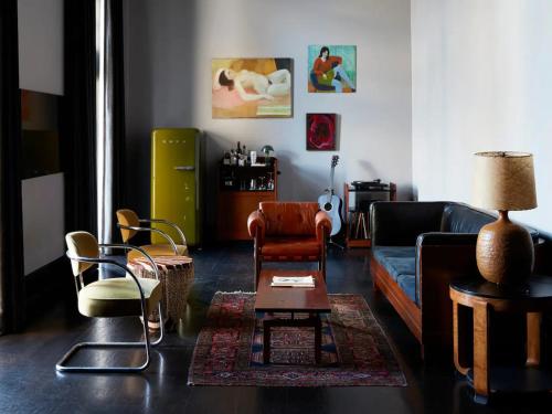 a living room with a couch and chairs at The Barnett, part of JdV by Hyatt in New Orleans