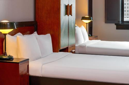 a hotel room with two beds and a lamp at The Barnett, part of JdV by Hyatt in New Orleans