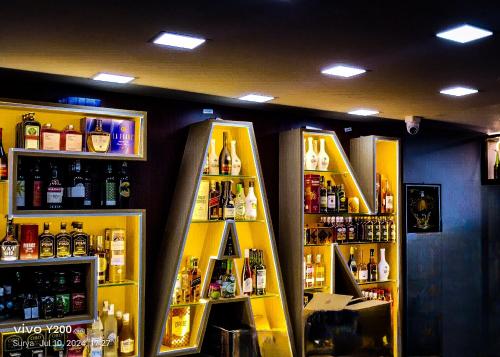 a store with a shelf with bottles of alcohol at SAN BEACH RESIDENCY in kāraikāl