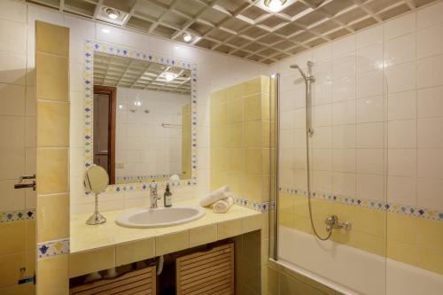 a bathroom with a sink and a shower and a mirror at The Right Place 4U Quercia Apartment in Rome