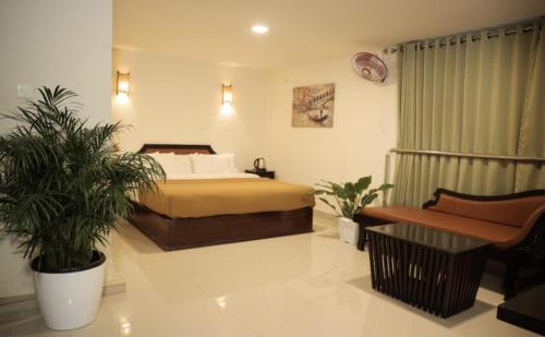 a bedroom with a bed and two plants in it at Wayanad Kuruva Isles Jungle Resort in Chekadi