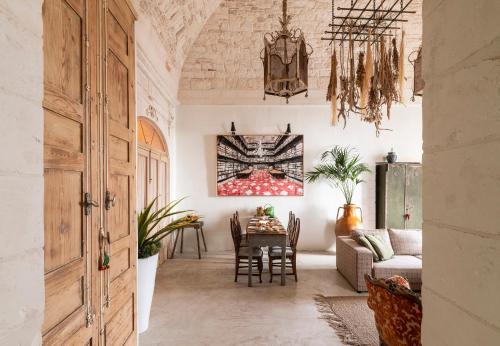 a living room with a table and a couch at Torretta Martina in Martina Franca