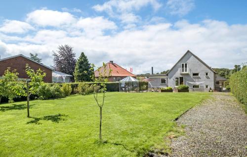 a yard with two small trees in the grass at Nice Home In Sydals With Wifi in Høruphav
