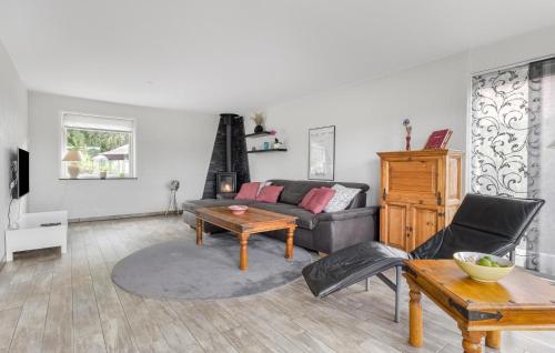 a living room with a couch and a table at Nice Home In Sydals With Wifi in Høruphav