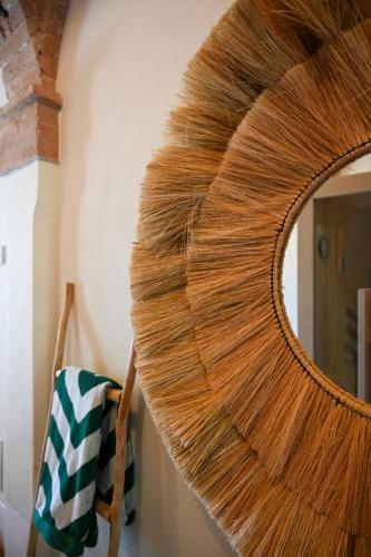 a mirror with a bunch of hair on a wall at Elizabeth Country House, a Member of Design Hotels in Minerbio