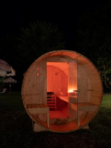 a small wooden circle with a room in the grass at Elizabeth Country House, a Member of Design Hotels in Minerbio
