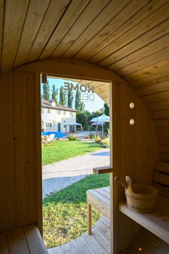 a door to a sauna with a view of a park at Elizabeth Country House, a Member of Design Hotels in Minerbio