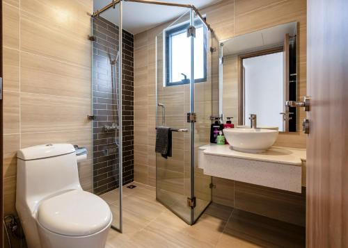 a bathroom with a toilet and a sink and a shower at Otis Soho Saigon Balcony Apartment in Ho Chi Minh City
