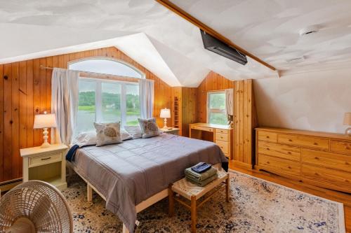 a bedroom with a bed and a window at Spacious 3BR Sunset Island Beach House in Wareham