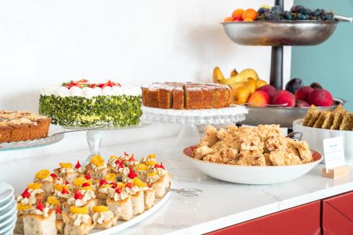a buffet with different types of cakes and other desserts at Garda Hotel Forte Charme in Nago-Torbole