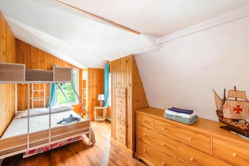 a bedroom with a bunk bed and a dresser at Spacious 3BR Sunset Island Beach House in Wareham