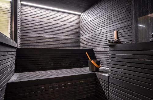 a sauna with a bench with a trash can at Garda Hotel Forte Charme in Nago-Torbole