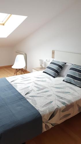 a bedroom with a large bed with blue pillows at Secretos de Teruel VUT-TE-24-0075 in Teruel