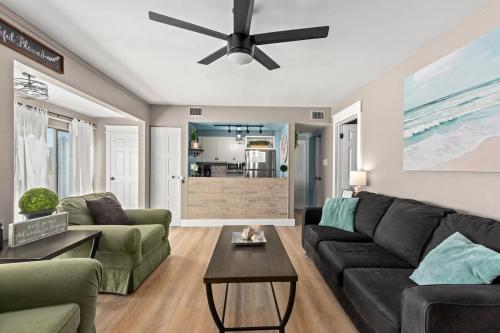 a living room with a couch and a ceiling fan at Catching Rays 3 Comm Pools Family & Pet friendly in Destin