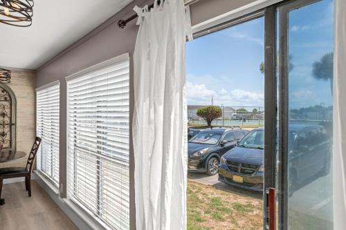 a window with a view of a parking lot at Catching Rays 3 Comm Pools Family & Pet friendly in Destin