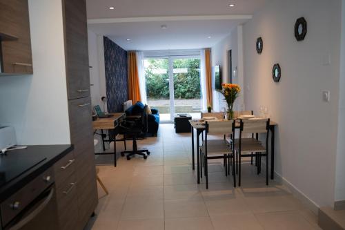 a kitchen and dining room with a table and chairs at Le Bathalzar in Villeneuve d'Ascq