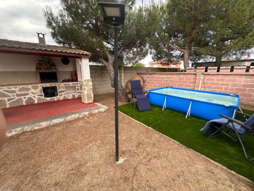 a pool in a yard next to a house at Casas Rurales La Picotilla y la Guija in Martiherrero