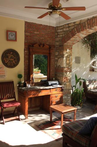 a living room with a desk and a ceiling fan at Villa Konak Hotel in Kusadası