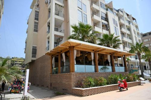 a building with a restaurant in front of it at Andi Apartments in Durrës