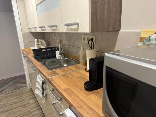 a kitchen with a sink and a counter top at Wellarom Szalon in Vonyarcvashegy